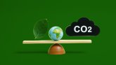 Green leaf globe and carbon dioxide balanced on a scale